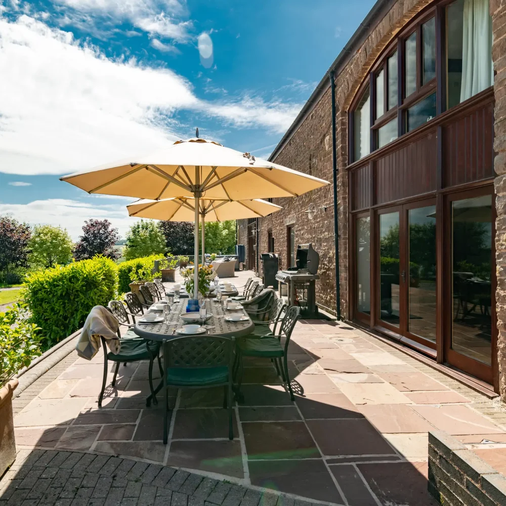 Raised patio with outdoor dining, BBQ, Pizza Oven, Comfortable Seating and Hot Tub, Penblaith Barn