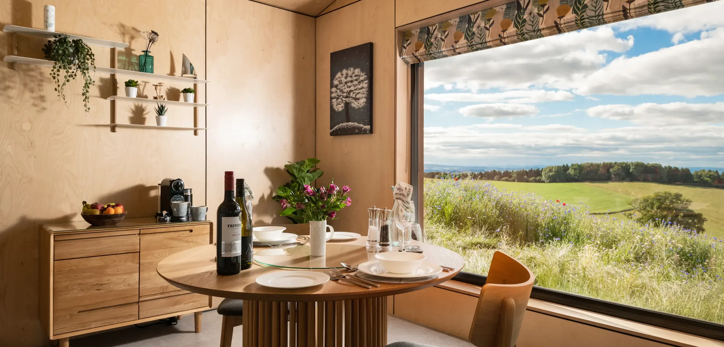 Dining table for two with far-reaching countryside views from inside Kestrel Retreat