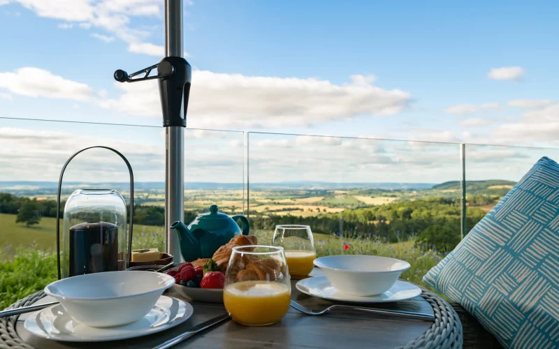 Outdoor dining for two overlooking far-reaching countryside views across multiple counties at Kestrel Retreat