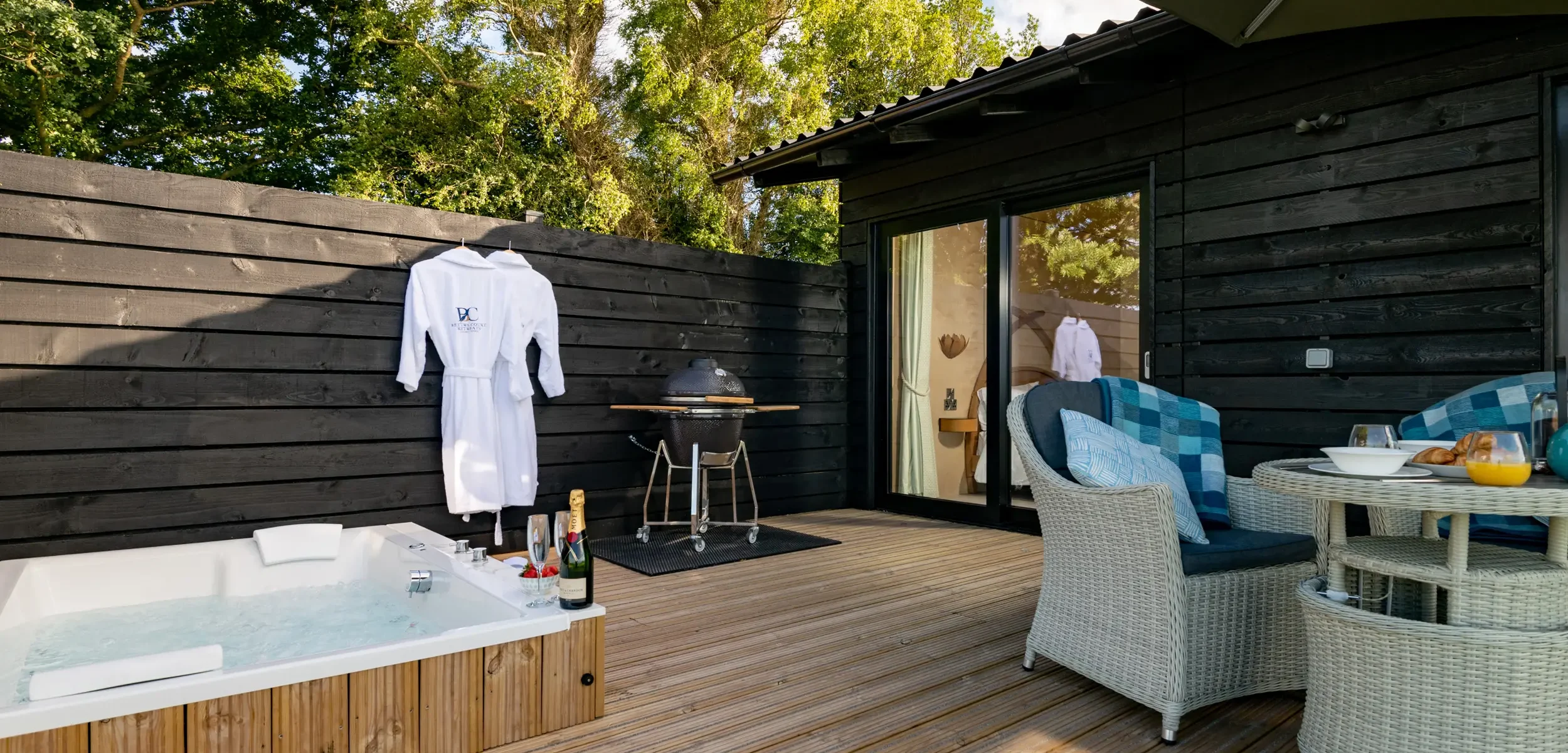 Private decking featuring a double spa bath, bathrobes, ceramic charcoal BBQ and outdoor dining for two at Kestrel Retreat