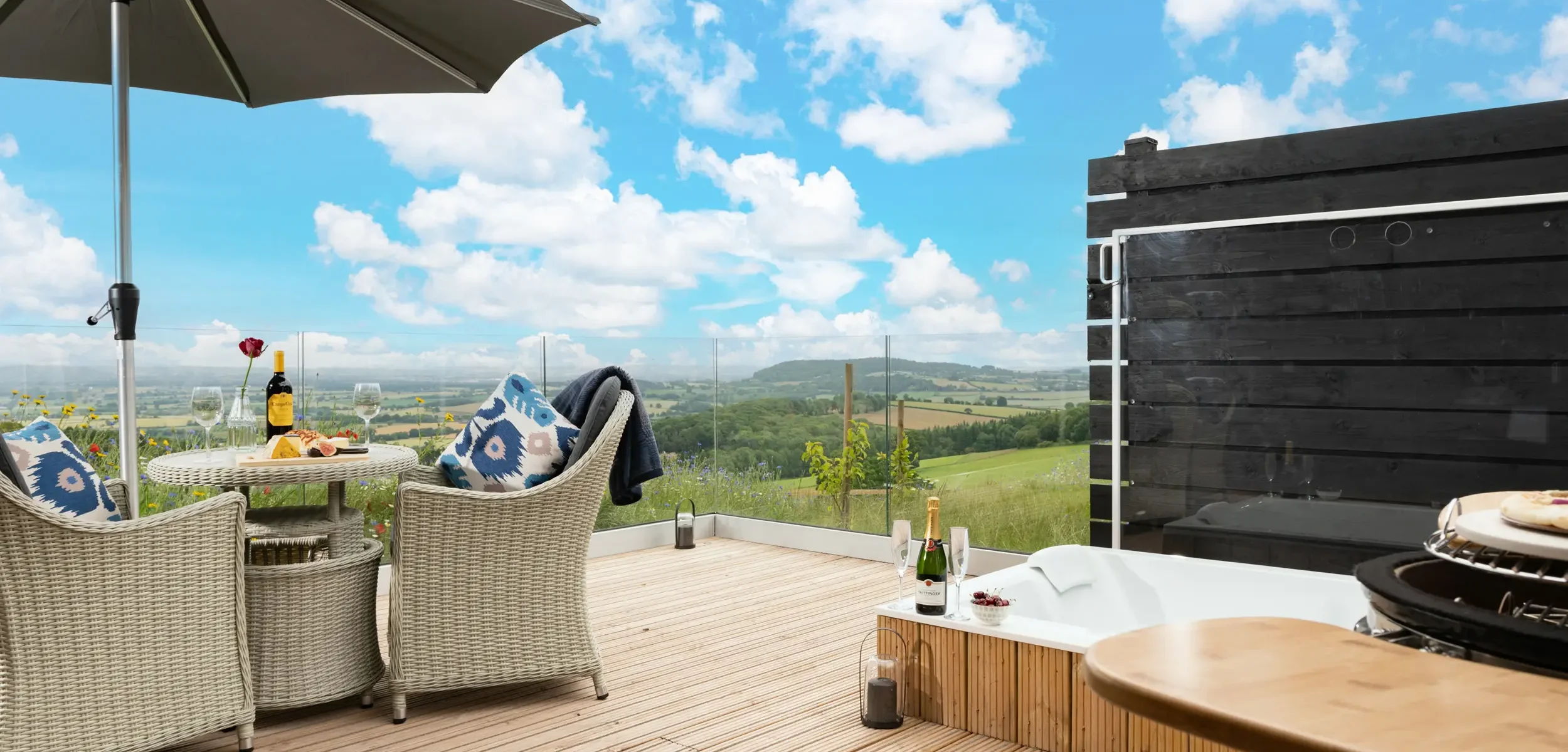 Ceramic charcoal BBQ, outdoor spa bath and seating on the private decking with stunning countryside views at Barn Owl Retreat