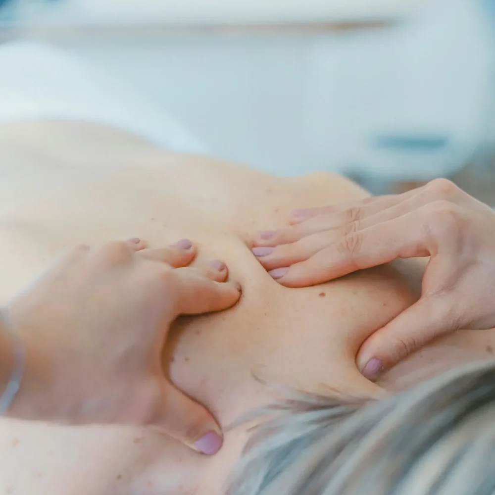Person enjoying a relaxing massage treatment during a peaceful getaway